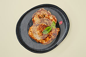 Top view of fried chopped pork tenderloin on a plate