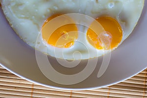 Top view fried eggs on dish