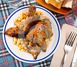 Top view of fried pig legs with chickpeas