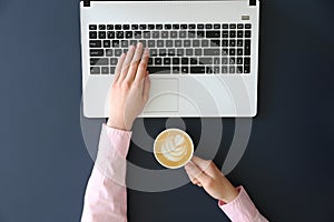 Top view of frmale hands on laptop keyboard