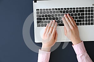 Top view of frmale hands on laptop keyboard