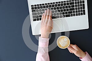 Top view of frmale hands on laptop keyboard