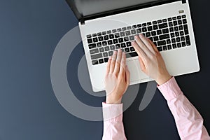 Top view of frmale hands on laptop keyboard