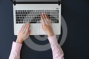 Top view of frmale hands on laptop keyboard photo