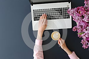 Top view of frmale hands on laptop keyboard photo