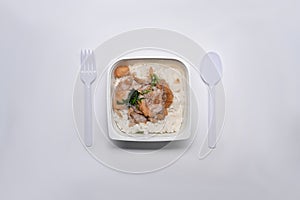 Frozen fried pork with garlic in plastic tray on white background.