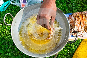 Top view of frying fish in a frying pan