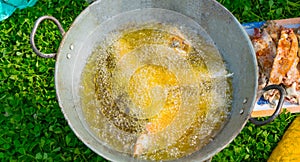 Top view of frying fish in a frying pan