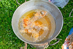 Top view of frying fish in a frying pan