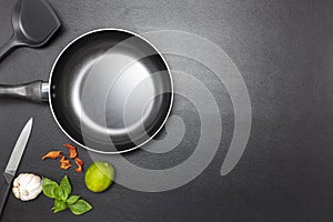 Top view frying pan on black leather table background