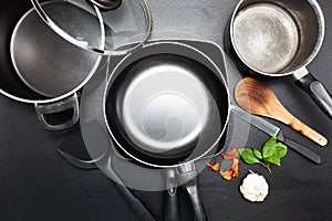 Top view frying pan and pot on black leather table image for coo