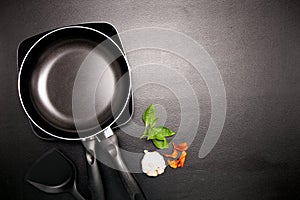 Top view frying pan and pot on black table