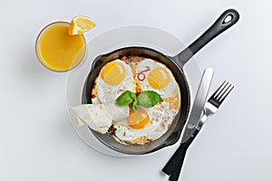 Top view of frying pan with three fried eggs