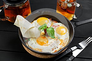 Top view of frying pan with three fried eggs