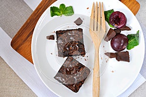 Top view of Fudge Brownie with Fresh Plum on Plate