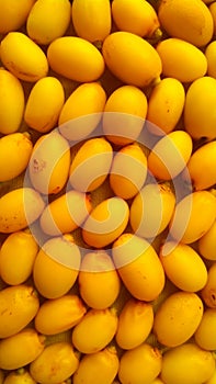 Top view full frame of yellow Neem fruits