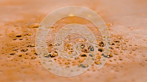 Top view of full glass of fresh beer with bubbles and foam. Freshly spilled golden alcoholic drink in glass. Foam and
