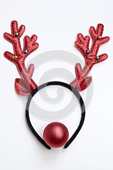 Top view funny Christmas antlers of a deer and a red ball as a nose isolated on white background