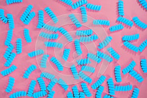 Top view of fusilli pasta on the bright blue green background.