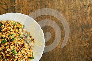 Top view fusion vegan food in Thai northern style Larp in white ceramic plate on wooden background