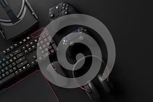 Top view of gamer workspace and gear like mouse, keyboard, joystick, headset, VR