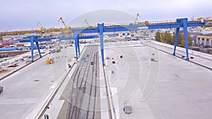 Top view of the gantry crane on the transport site. Clip. Various brands and colours of Shipping containers stacked by