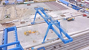 Top view of the gantry crane on the transport site. Clip. Various brands and colours of Shipping containers stacked by