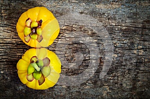 Top view. Garcinia cambogia fresh fruit on wood background. Fr