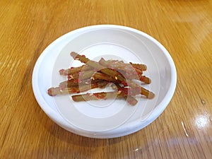 Top view of garlic stalk with sesame in white plate on wooden table, Kimchi is korea traditiona
