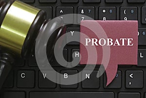 Top view of a gavel, computer keyboard and a red speech bubble written with Probate