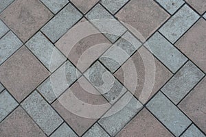Top view of geometric pavement made of grey and brown tiles