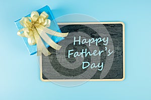 Top view gift box on blue background with copy space for text, preparation for fathers. World International men day, Fatherâ€™s