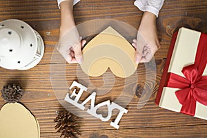 Top view of gift box with Christmas decorations over wooden table, holiday and background concept