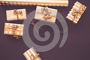 Top view of gift boxes in golden designs. Flat lay, copy space. A concept of Christmas, New Year, birthday celebration