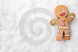 Top view of gingerman on snowy background with copy space