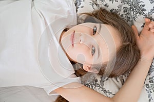 Top view girl lying in bed idle in quarantine