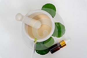 Top view glass beaker containing water and Centella asiatica decorated with erlenmeyer flask and round podium