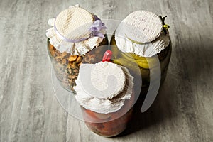 top view on glass jars with homemade canned vegetables