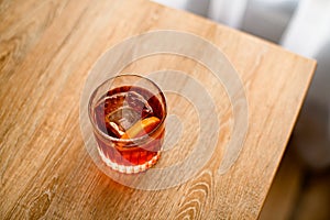 Top view on glass with negroni cocktail stands on table