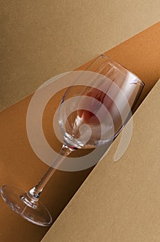 Top view of glass of red wine on the brown and orange colored surface.Vertical image.Concept of wine tasting