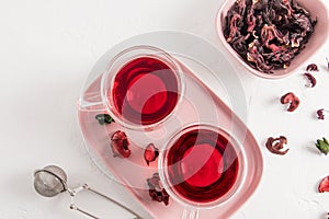 Top view of glass transparent cups with hibiscus tea made of dry rose petals. delicious healthy drink, vitamin tea for colds and