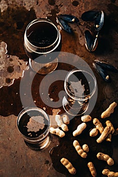 top view of glasses of cold beer peanuts and mussels shells