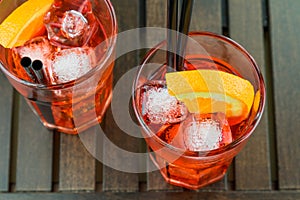 Top of view of glasses of spritz aperitif aperol red cocktail with orange slices and ice cubes