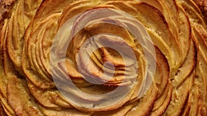 Top view of golden baked traditional apple pie, rotating. Close up of French apple tart