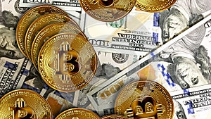 Top view golden bitcoin with money banknote one hundred dollars bills in background. Business finance and object concept photo