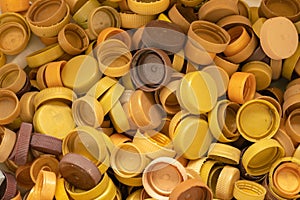Top view golden color collection of LDPE plastic bottle cap remove lid waste for recycle process background.for environment issue,