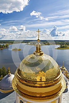 Top view of the golden domes of the Epiphany cathedral nilo-Stolobenskaya desert on the background of lake Seliger.