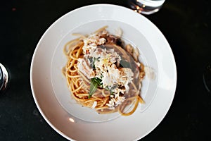 Top View of Gourmet Spaghetti with Crab Meat Served on a round white plate