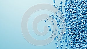 The top view of granules of blue plastic polypropylene granules on a blue background, with a masterbatch polymer grain pile