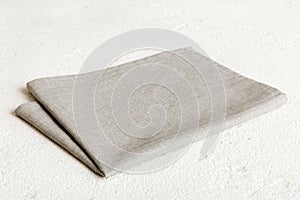 top view with gray kitchen napkin isolated on table background. Folded cloth for mockup with copy space, Flat lay